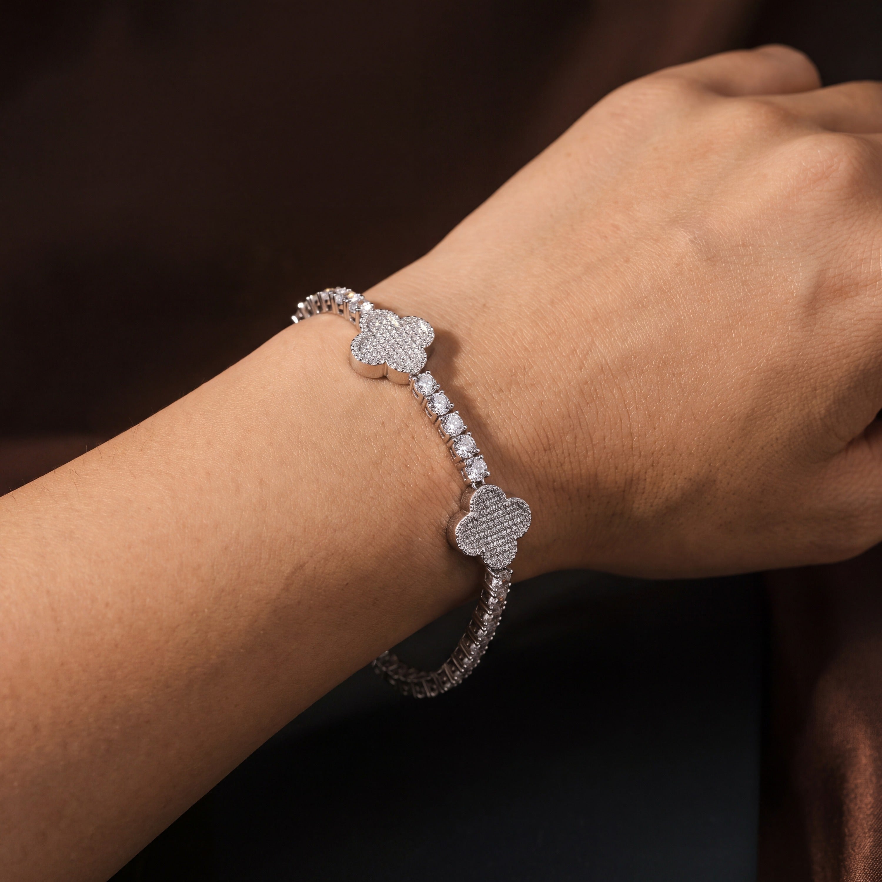 Four-leaf clover tennis bracelet seen from a second angle on the wrist